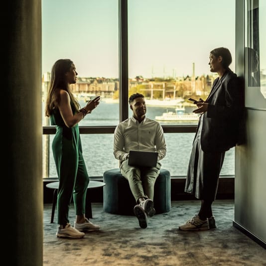 People at a coworking space in Stockholm with panoramic view over the city
