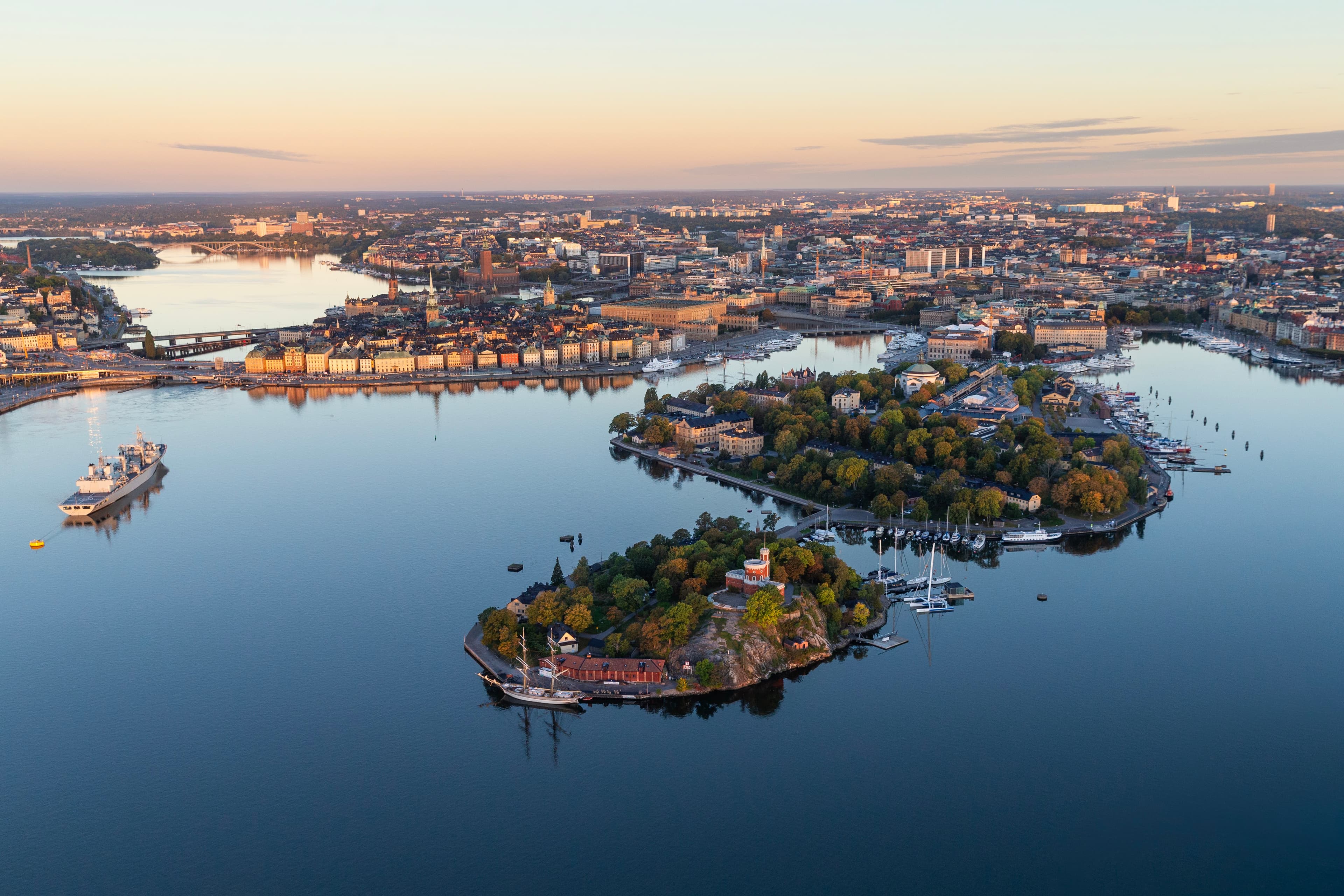 Aerial view of central Stockholm with islands, water and the city skyline at sunset.